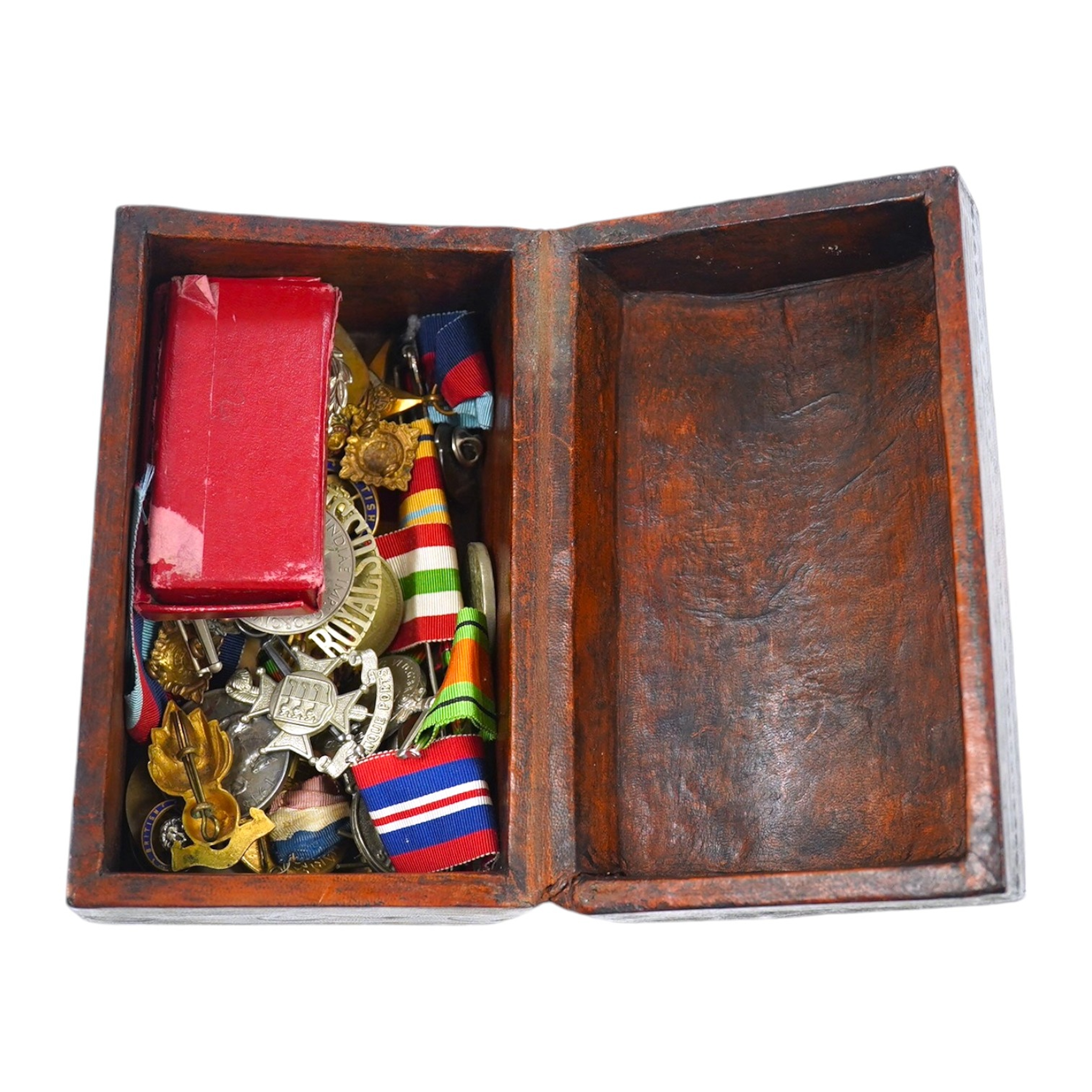 An assortment of WWI interest and other medals and related matter to include badges and brooches, some with enamel, housed in a domed box, together with two swagger sticks, Condition - mostly fair